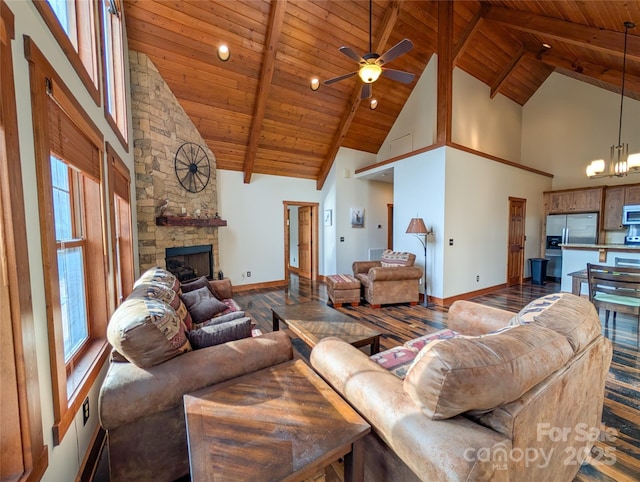 living room with wooden ceiling, dark wood-style floors, beamed ceiling, and a stone fireplace