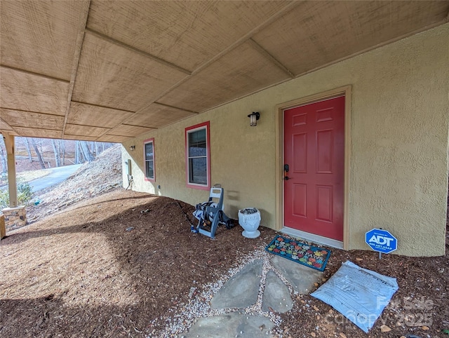 property entrance with stucco siding