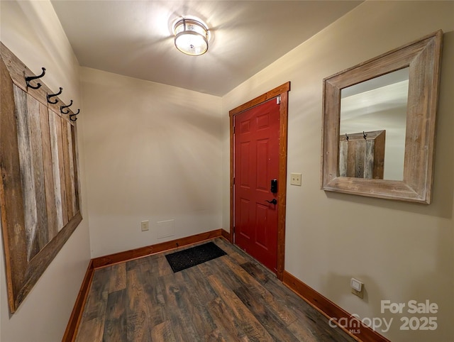 foyer entrance with baseboards and dark wood-style flooring