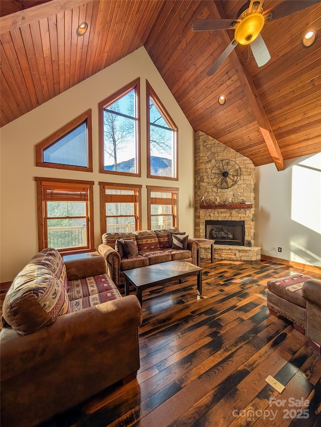 living area with high vaulted ceiling, wooden ceiling, a stone fireplace, and hardwood / wood-style floors