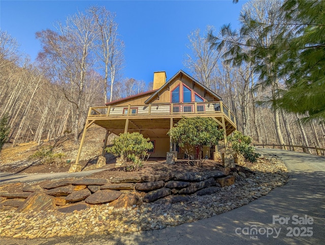 view of front of property featuring a deck and a chimney