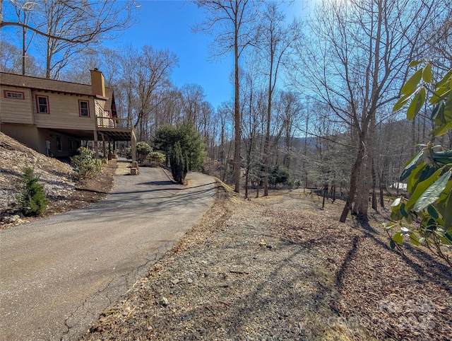 view of street featuring driveway and stairway