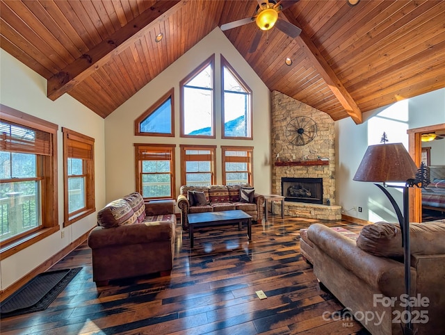 living room featuring a stone fireplace, a ceiling fan, beam ceiling, and hardwood / wood-style floors