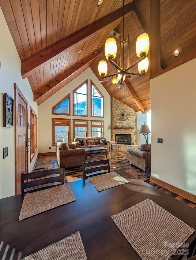 living room with high vaulted ceiling, beamed ceiling, wood ceiling, and a chandelier