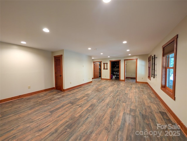 interior space featuring dark wood-type flooring, recessed lighting, and baseboards