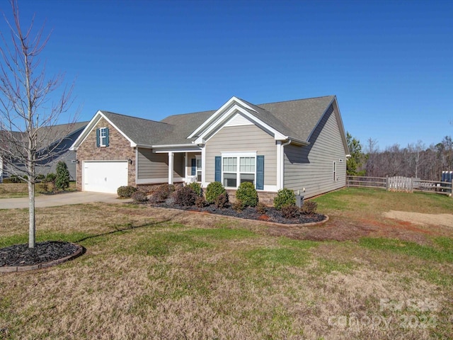 view of front of house featuring a garage and a front lawn