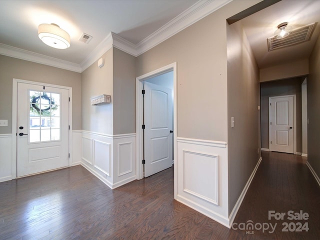 entryway with dark hardwood / wood-style flooring and ornamental molding