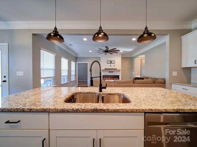 kitchen featuring sink, ceiling fan, light stone countertops, ornamental molding, and white cabinetry