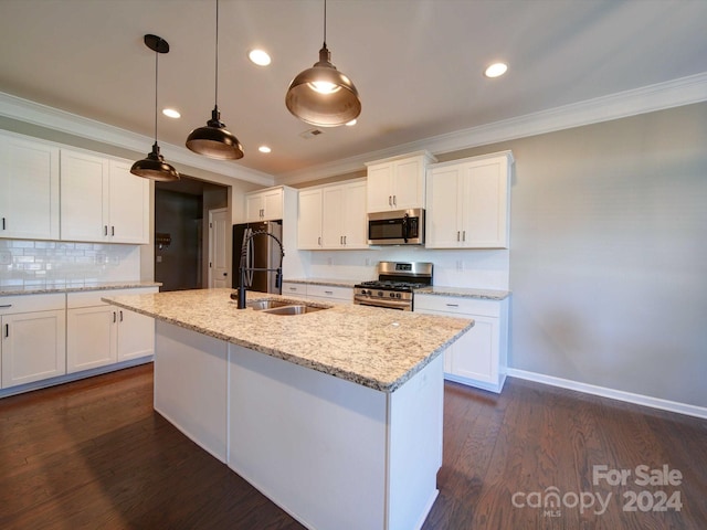 kitchen with appliances with stainless steel finishes, dark hardwood / wood-style floors, white cabinetry, and hanging light fixtures