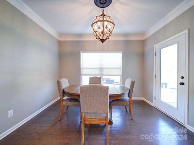 dining area featuring dark hardwood / wood-style flooring, ornamental molding, and an inviting chandelier