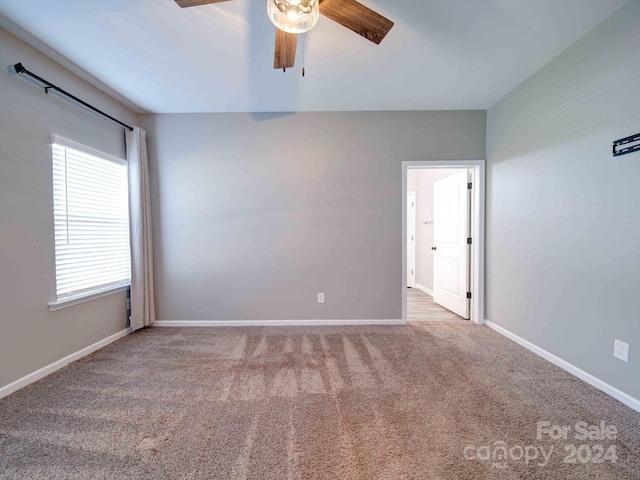 carpeted empty room with ceiling fan