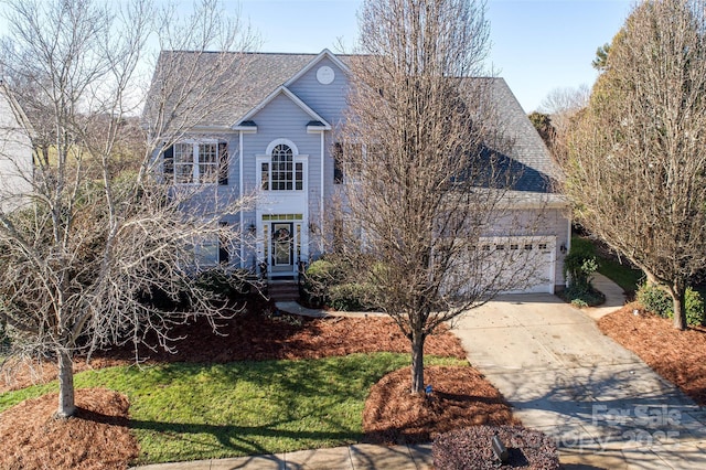 front facade featuring a front yard and a garage