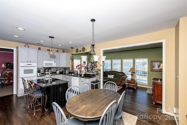 dining space with dark hardwood / wood-style floors and sink