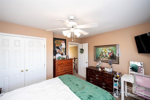 carpeted bedroom featuring ceiling fan and a closet