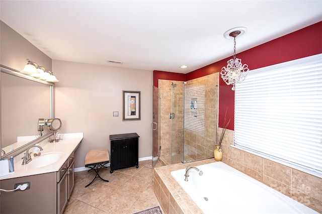 bathroom featuring tile patterned flooring, vanity, shower with separate bathtub, and a chandelier