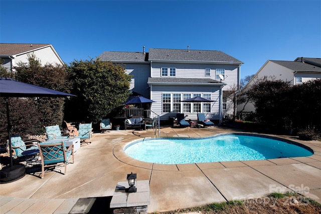 view of swimming pool with a patio area