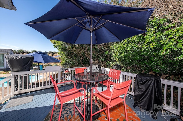 wooden deck featuring a grill