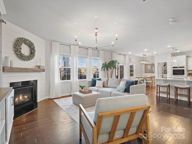 living room featuring dark hardwood / wood-style flooring and a fireplace