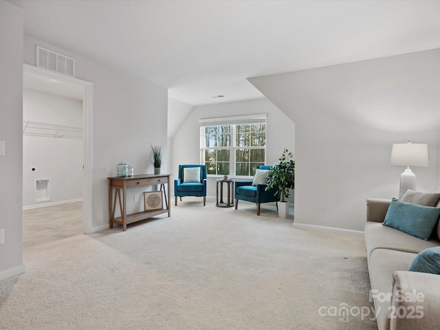 sitting room with light colored carpet and lofted ceiling