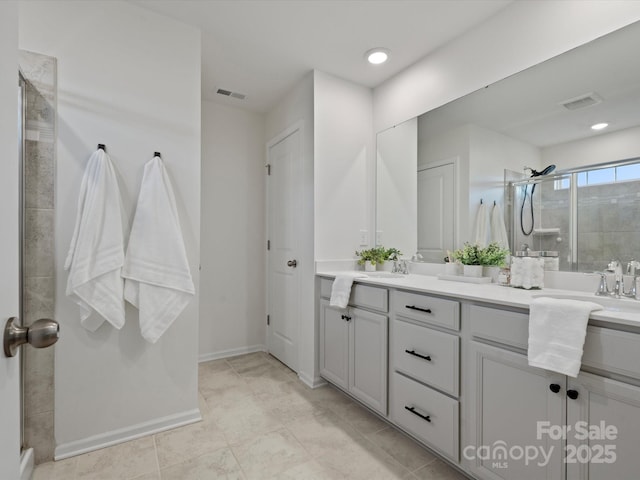 bathroom featuring an enclosed shower and vanity