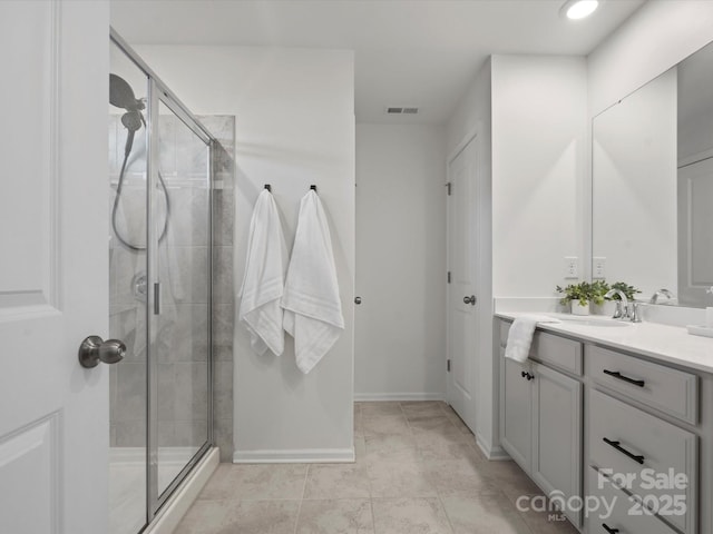 bathroom featuring vanity, tile patterned flooring, and walk in shower