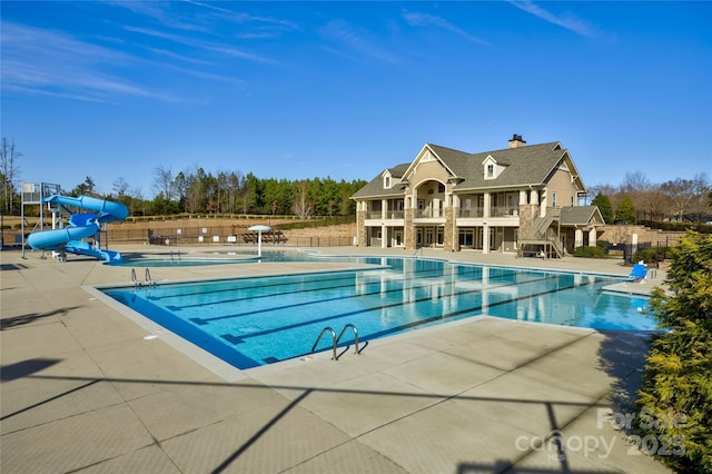 view of pool featuring a patio area and a water slide