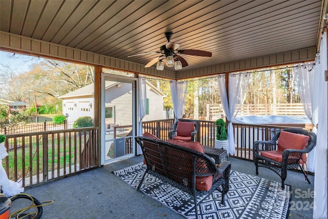 sunroom / solarium with ceiling fan and wood ceiling