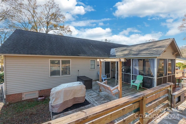 back of house with a deck and a sunroom