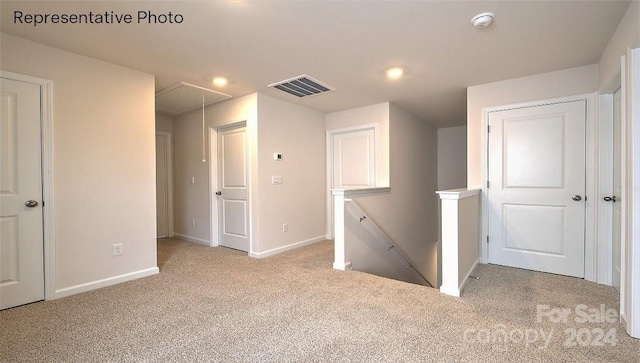 hallway featuring light colored carpet