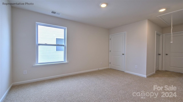 empty room featuring light carpet