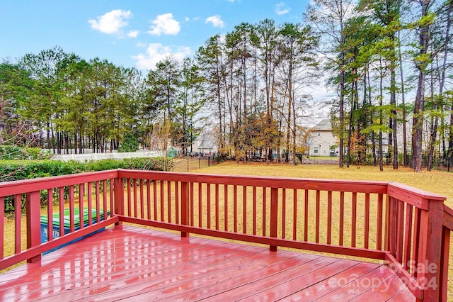 wooden deck with a lawn