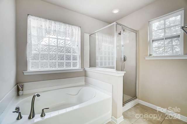 bathroom featuring tile patterned floors and separate shower and tub