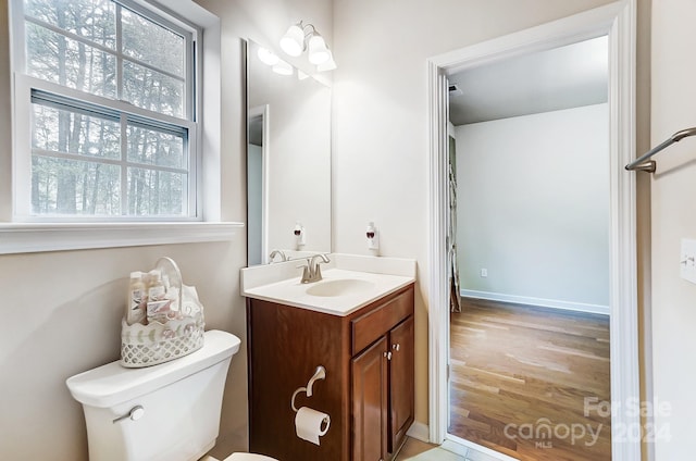 bathroom featuring vanity, toilet, and wood-type flooring