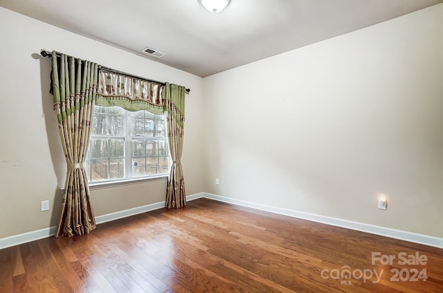 unfurnished room featuring hardwood / wood-style floors