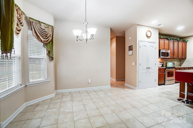 kitchen with backsplash, decorative light fixtures, appliances with stainless steel finishes, a notable chandelier, and light tile patterned flooring