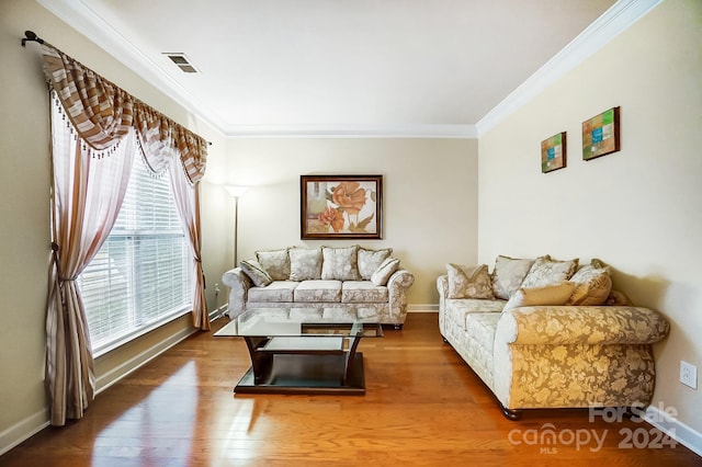 living room featuring wood-type flooring and ornamental molding