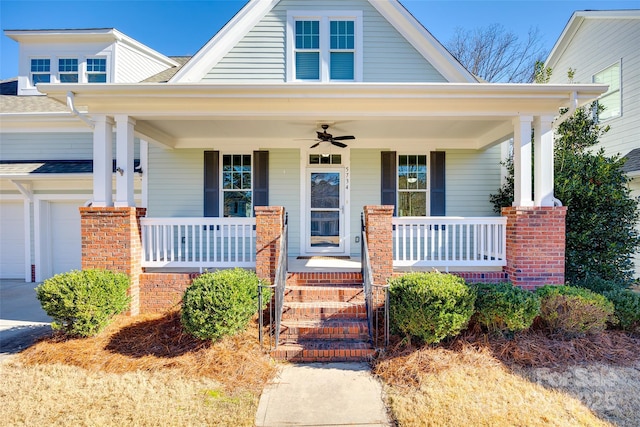 view of front of property with covered porch, a garage, and ceiling fan