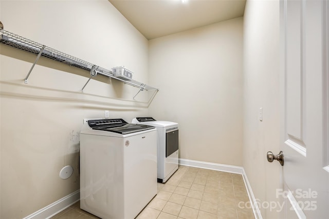 washroom with separate washer and dryer and light tile patterned flooring