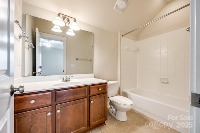 full bathroom with vanity, tile patterned floors, tiled shower / bath, vaulted ceiling, and toilet