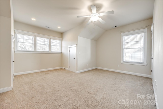 additional living space with light carpet, ceiling fan, and lofted ceiling