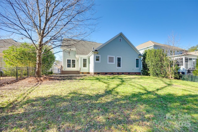 rear view of house with a yard