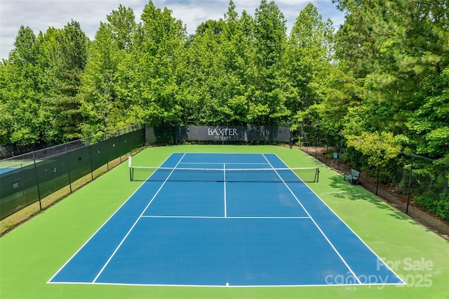 view of tennis court featuring basketball hoop