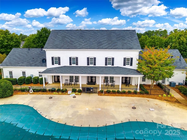 exterior space with french doors, a patio, a covered pool, and cooling unit