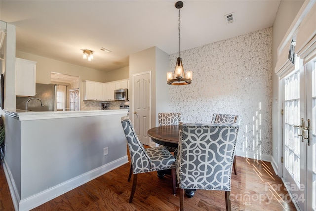 dining room featuring a notable chandelier and wood-type flooring