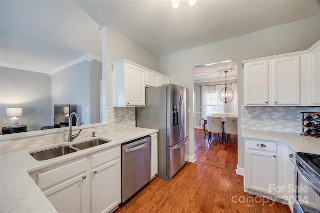 kitchen with stainless steel appliances, tasteful backsplash, light hardwood / wood-style floors, and sink