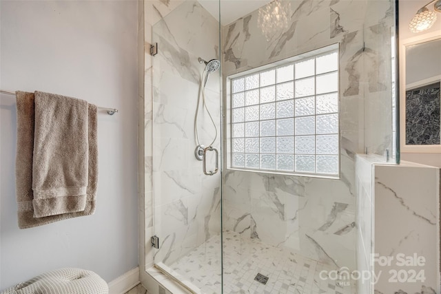 bathroom featuring a shower with shower door