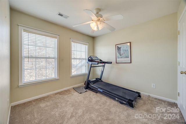 workout room with light carpet and ceiling fan