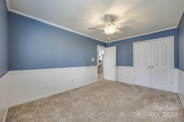 unfurnished bedroom featuring a closet, ceiling fan, and crown molding