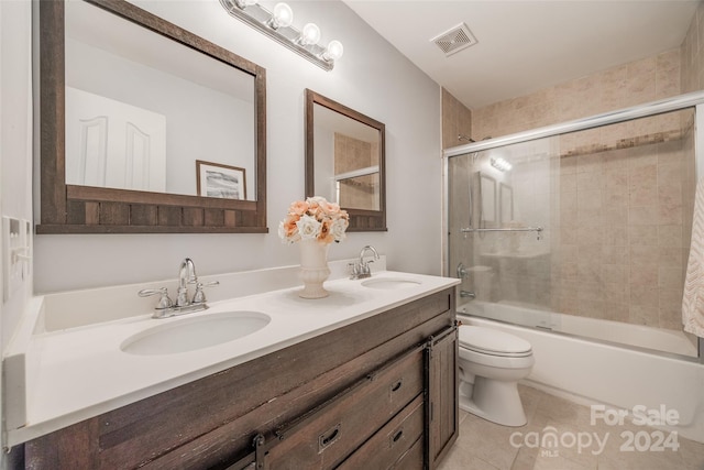 full bathroom with tile patterned floors, toilet, combined bath / shower with glass door, and vanity