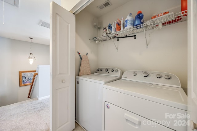 washroom featuring carpet and washer and dryer